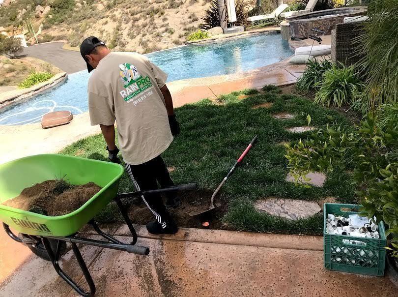 Rain Pro crew member working near a backyard pool
