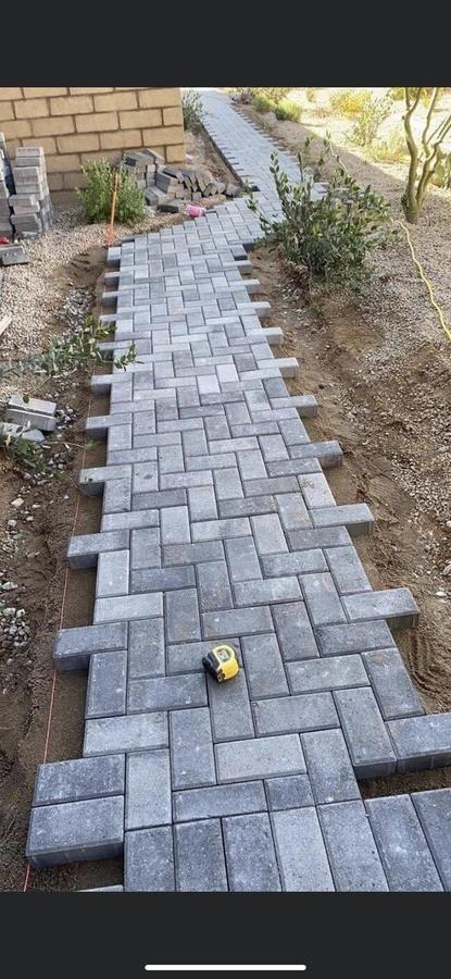 Herringbone paver walkway being installed